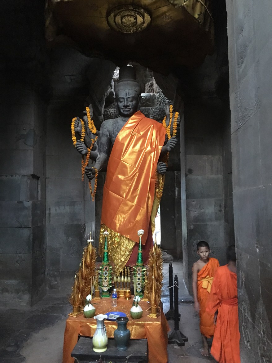 Child Buddhist monks tending to an Angkor Wat temple. Some Reap, Cambodia